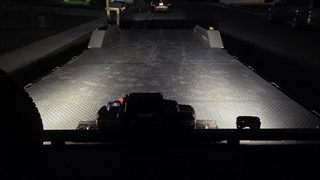 Car hauler deck lit by LED lights at night