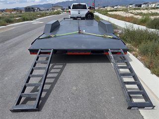 Car hauler rear view with both ramps down for loading