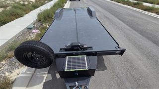 Car hauler tongue box with solar battery charger and spare tire