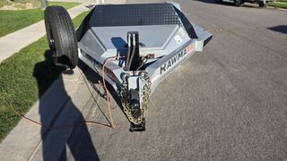 Tongue with hydraulic jack, coupler, safety chains and spare tire